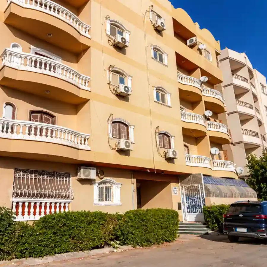 Sunlit Beige Apartment Building Exterior